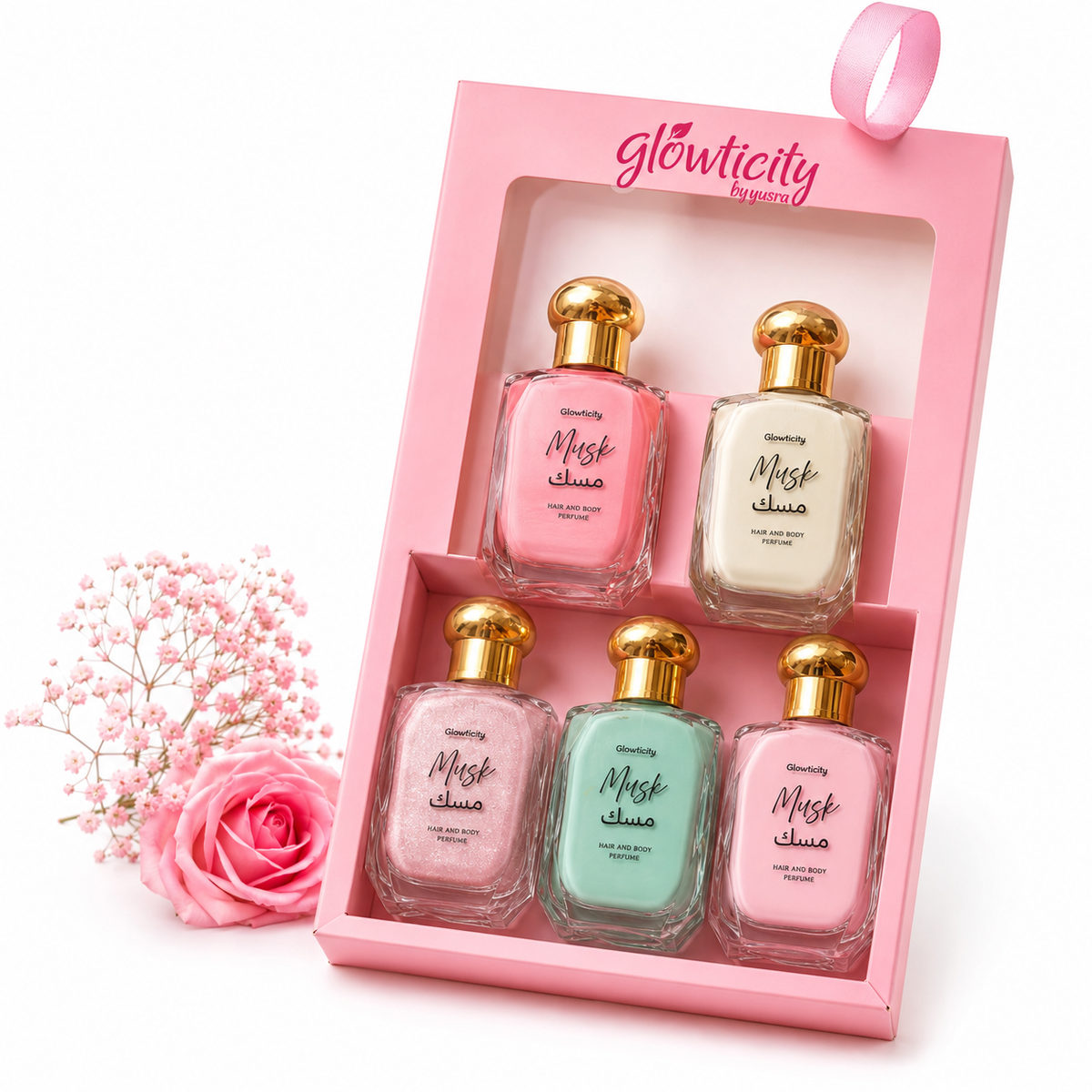 Five Glowticity Musk hair and body perfume bottles in a pink Glowticity gift box with roses